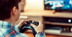 boy playing a video game holding controller