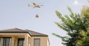 Wing drone making a delivery to a customer house